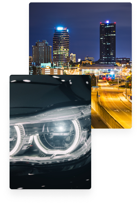 Closeup View of Black Car Headlight and City at Night | European Auto Garage